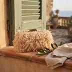 Champagne fringe mini bag styled in a warm Mediterranean setting