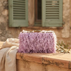 Lavender fringe mini bag styled in a warm Mediterranean setting