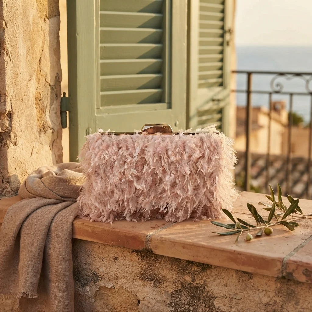 Pink fringe mini bag styled in a warm Mediterranean setting