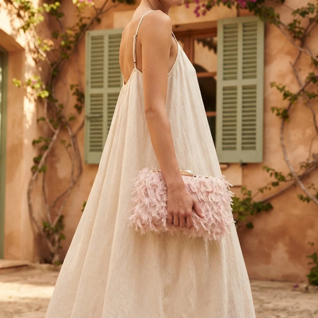 Woman wearing Pink fringe mini bag with swaying fringe