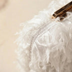 Close-up of fringe stitching and texture on White fringe mini bag