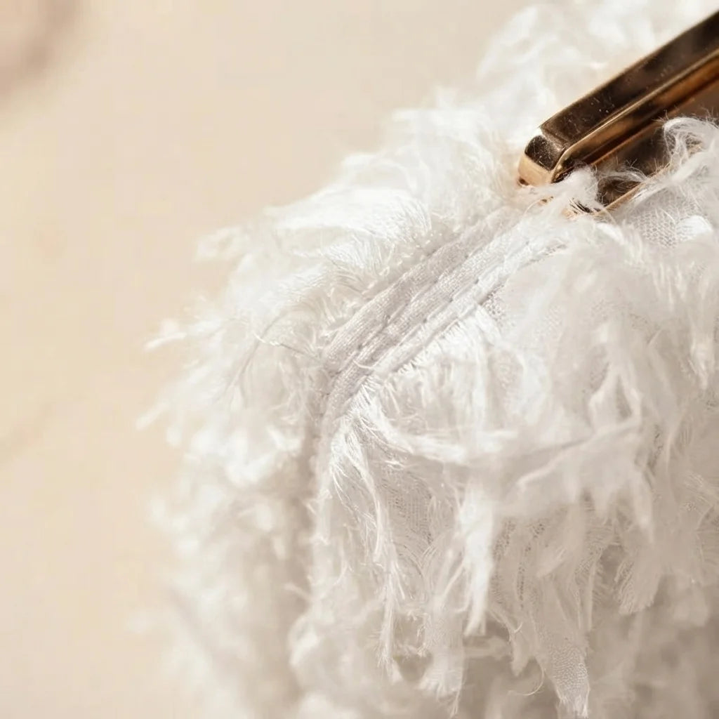 Close-up of fringe stitching and texture on White fringe mini bag