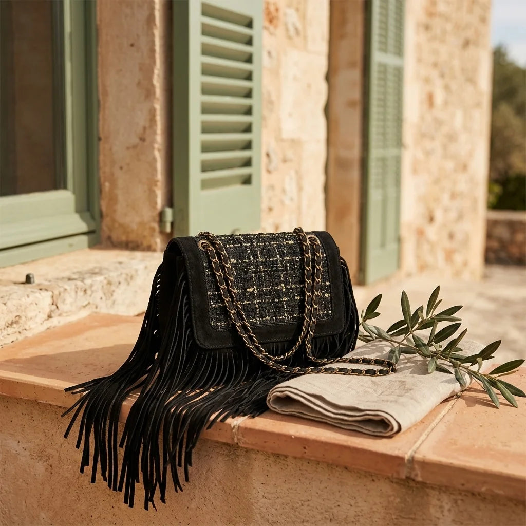Black fringe over shoulder bag styled in a warm Mediterranean setting