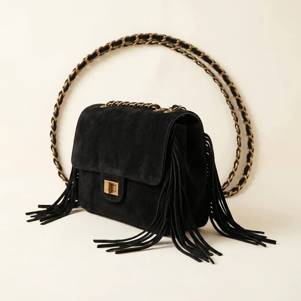 Black fringe over shoulder bag, three-quarter angle showing side depth