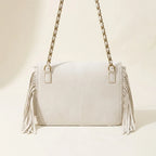 Back panel of White fringe over shoulder bag with strap attachments