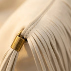 Close-up of fringe stitching and texture on White fringe over shoulder bag