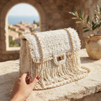 White fringe over shoulder bag, three-quarter angle showing side depth