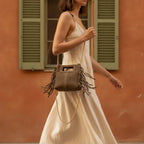 Woman wearing Beige fringe satchel bag with swaying fringe
