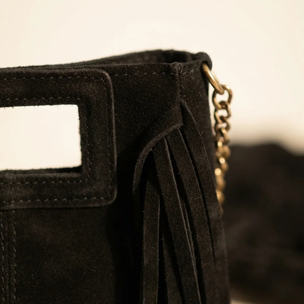Close-up of fringe stitching and texture on Black fringe satchel bag