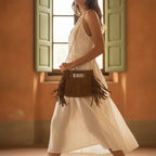 Woman wearing Camel fringe satchel bag with swaying fringe