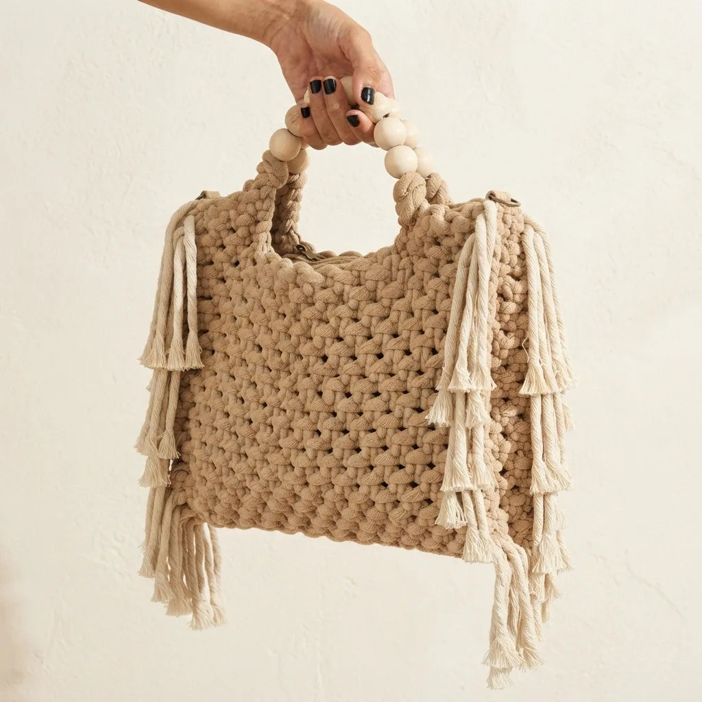 Beige fringe shoulder bag with tassels, three-quarter angle showing side depth