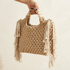 Beige fringe shoulder bag with tassels, three-quarter angle showing side depth