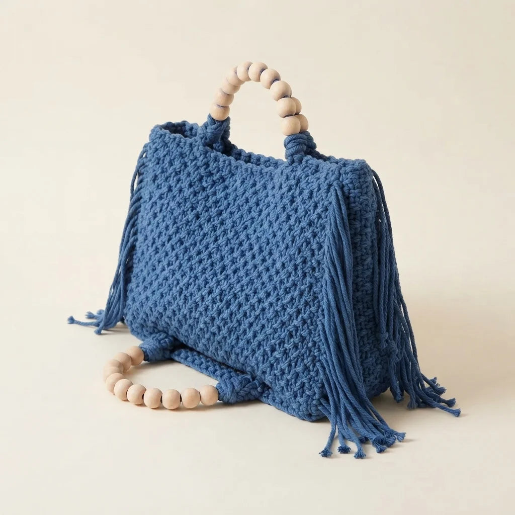Blue fringe shoulder bag with tassels, three-quarter angle showing side depth