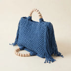 Blue fringe shoulder bag with tassels, three-quarter angle showing side depth