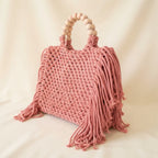 Pink fringe shoulder bag with tassels, three-quarter angle showing side depth