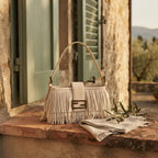 Cream fringe shoulder bags designer styled in a warm Mediterranean setting