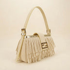 Cream fringe shoulder bags designer, three-quarter angle showing side depth