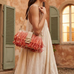Woman wearing Orange fringe shoulder bags designer with swaying fringe