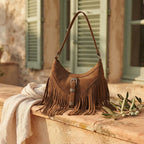 Coffee fringe sling bag styled in a warm Mediterranean setting