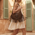 Woman wearing Coffee fringe sling bag with swaying fringe