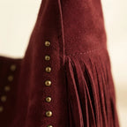 Close-up of fringe stitching and texture on Burgundy fringe studded bag