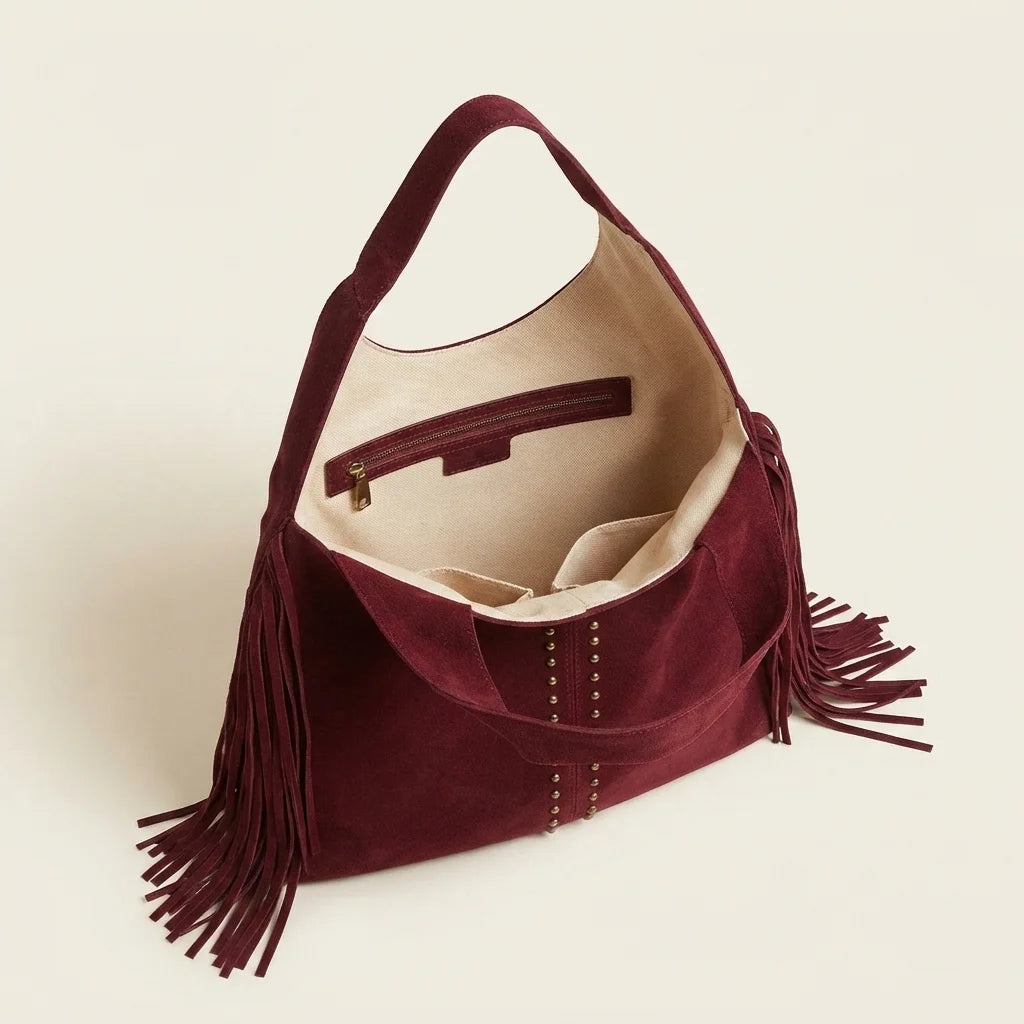 Interior lining and pockets of Burgundy fringe studded bag