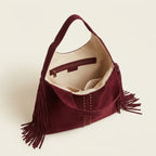 Interior lining and pockets of Burgundy fringe studded bag