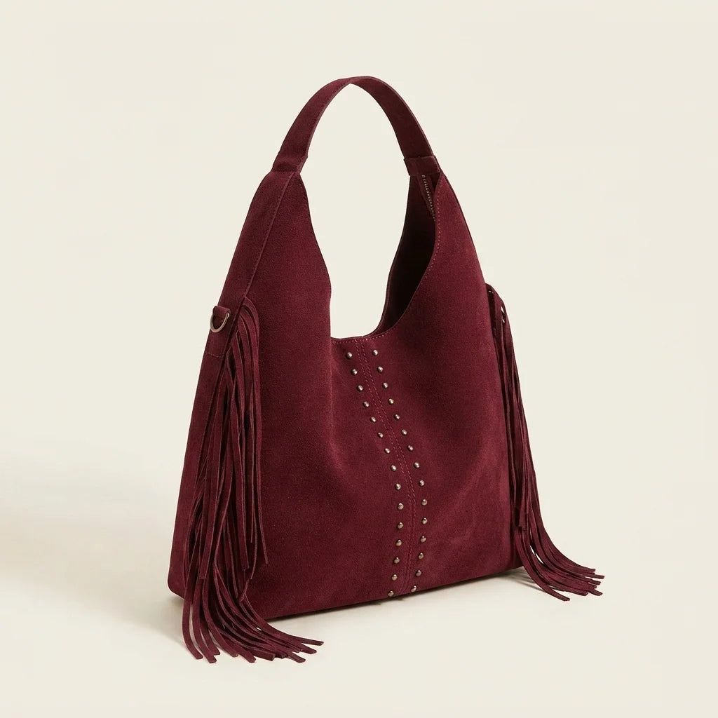 Burgundy fringe studded bag, three-quarter angle showing side depth