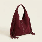 Burgundy fringe studded bag, three-quarter angle showing side depth