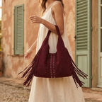 Woman wearing Burgundy fringe studded bag with swaying fringe