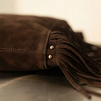 Close-up of fringe stitching and texture on Coffee fringe studded bag