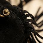 Close-up of fringe stitching and texture on Black fringe suede belt bag