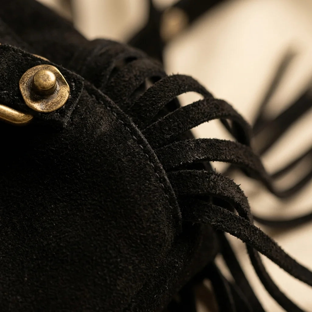 Close-up of fringe stitching and texture on Black fringe suede belt bag
