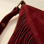 Close-up of fringe stitching and texture on Red fringe suede belt bag