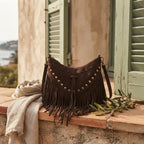 Coffee fringe tassel crossbody bag styled in a warm Mediterranean setting