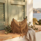 Khaki fringe tassel crossbody bag styled in a warm Mediterranean setting
