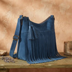 Blue fringe tassel shoulder bag, three-quarter angle showing side depth