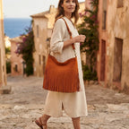 Woman wearing Orange fringe tassel shoulder bag with swaying fringe