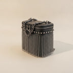 Black fringe tassel small bag, three-quarter angle showing side depth