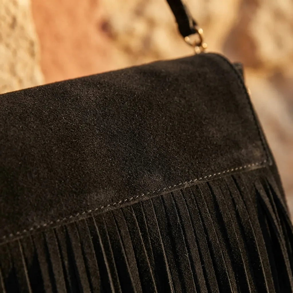 Close-up of fringe stitching and texture on black fringed-shoulder-bag-black-and-white