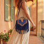 Woman wearing Blue fringed suede sling bag with swaying fringe