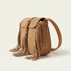 Camel fringed suede sling bag, three-quarter angle showing side depth