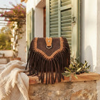 Dark Brown fringed suede sling bag styled in a warm Mediterranean setting