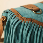 Close-up of fringe stitching and texture on Turquoise fringed suede sling bag