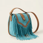 Turquoise fringed suede sling bag, three-quarter angle showing side depth