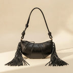 Back panel of Black genuine leather fringe bag with strap attachments