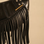 Close-up of fringe stitching and texture on Black genuine leather fringe bag