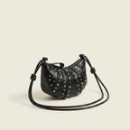 Black genuine leather fringe bag, three-quarter angle showing side depth