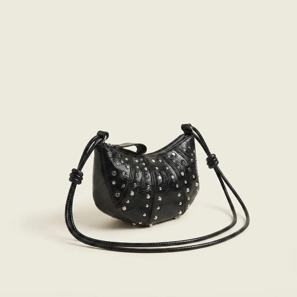 Black genuine leather fringe bag, three-quarter angle showing side depth