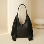 Back panel of Black genuine leather fringe hobo bag with strap attachments